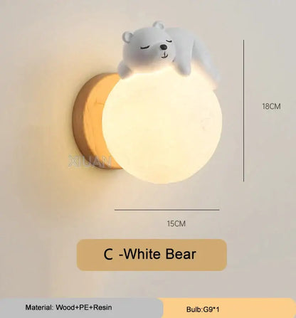 A soft white spherical wall lamp with a cute sleeping bear figurine in a whimsical bear wall lamp for kids bedroom