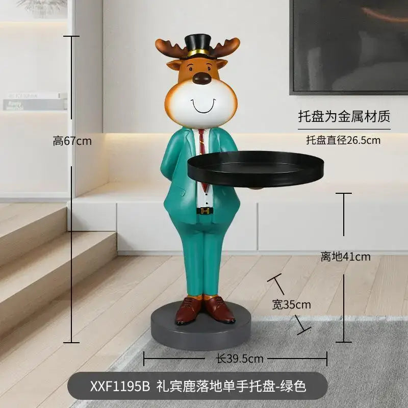 A charming green-suited deer landing tray ornament with top hat and brown shoes holding a black metal tray