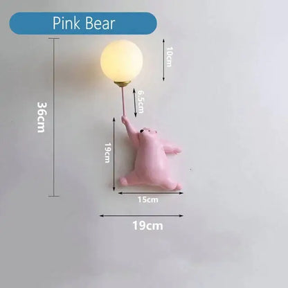Whimsical pink polka dot girl wall lamp featuring a bear holding a warm-toned round bulb for bedroom lighting