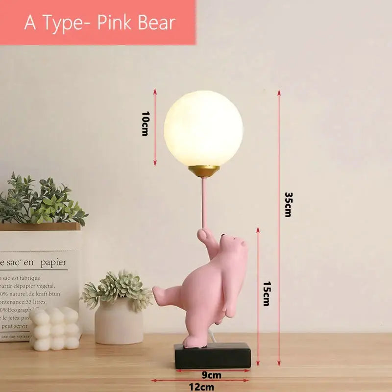 Whimsical pink bear moon lamp with spherical white glass shade and gold-toned base for bedroom decor