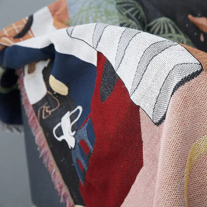 Whimsical space themed decorbites knit sofa blanket with colorful abstract design and fringe detailing for living room decor