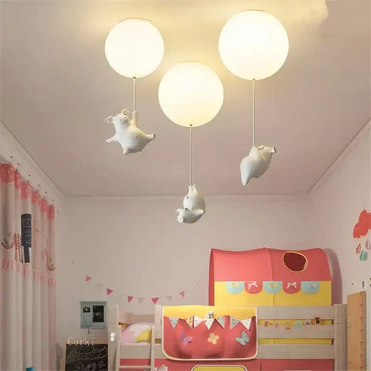 Whimsical white balloon ceiling light featuring three flying pig resin led figurines for bedroom decor