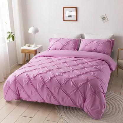 Pink quilted duvet cover set with satin-like finish and diamond-shaped tufting for elegant bedroom bedding