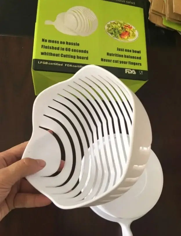White plastic easy salad cutter bowl with black slotted design for effortless kitchen vegetable slicing
