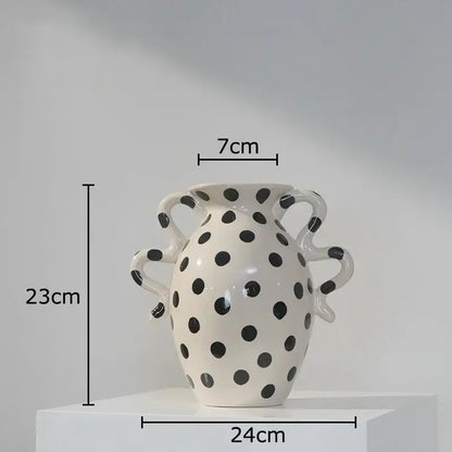 White ceramic vase with black polka dot pattern and sculpted handles for living room decor