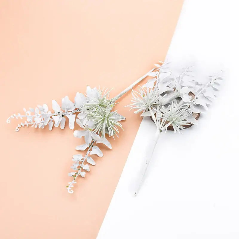 White artificial eucalyptus and air plant floral arrangement with frosted leaves in decorbites decorative flowers wedding bouquet