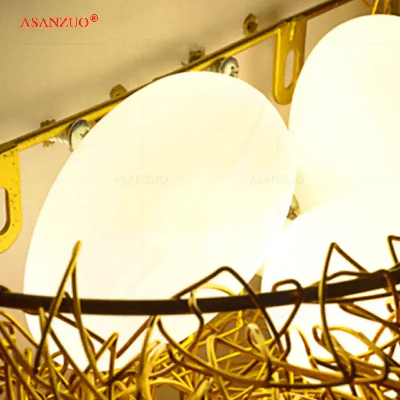White and gold ceramic birds nest wall lamp with gold-toned wire nest chandelier and frosted glass shades for children room