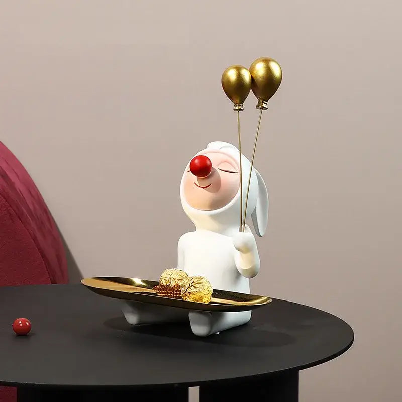 White and gold ceramic clown bust sculpture holding gold balloons and tray with chocolates for kids room candy display