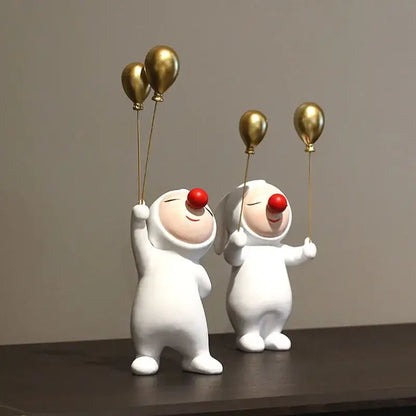 White and gold ceramic clown bust sculpture with red noses holding balloons for kids room candy tray decor