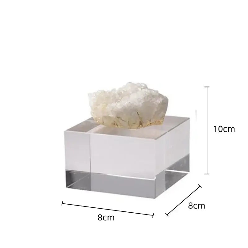 A translucent acrylic stand displaying a white crystalline geode with delicate branching formations for crystal coralline ornaments living room decor