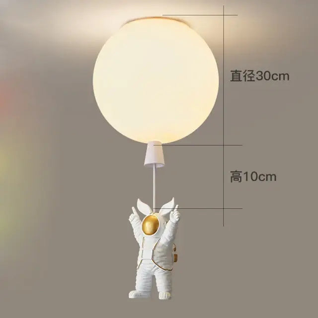 White and gold decorbites astronaut space ball ceiling lamp featuring a white astronaut figurine holding a glowing light sphere