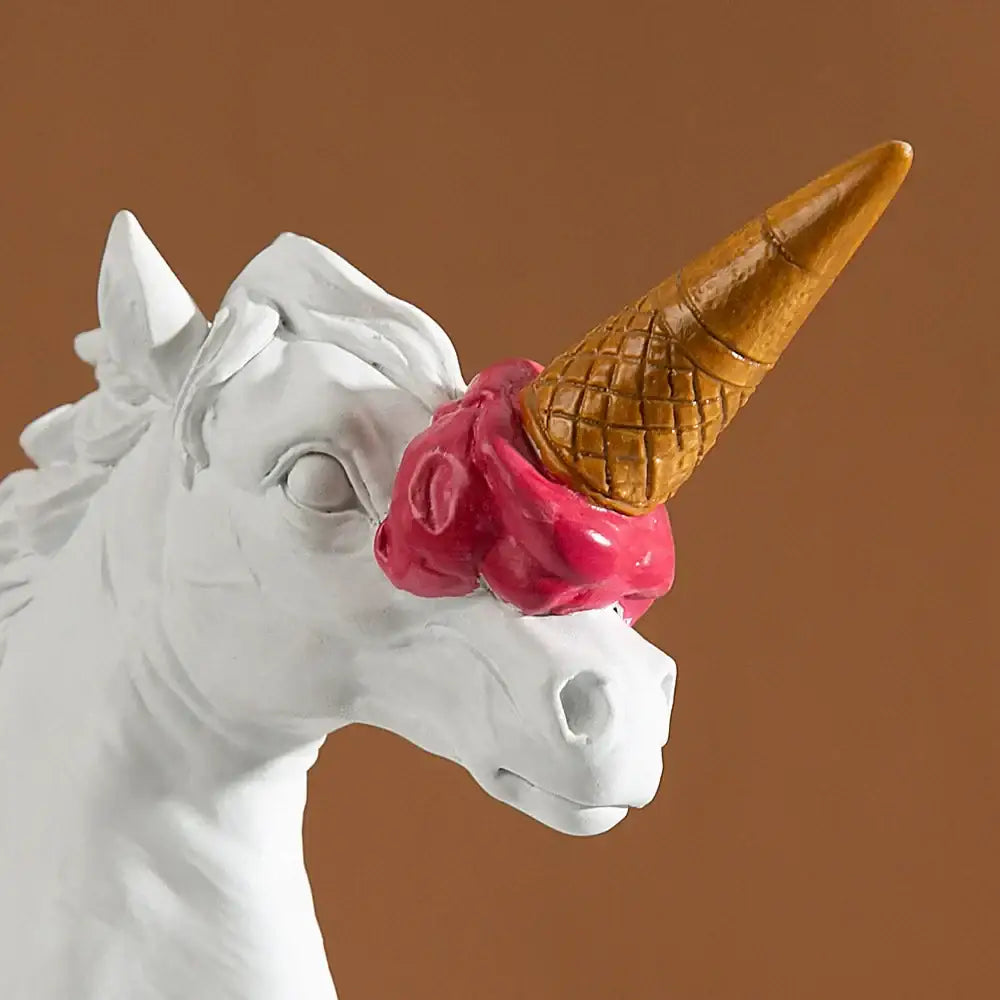 White and gold ice cream horse head sculpture featuring a white horse head with a golden waffle cone horn and pink swirl decorbites ice cream decor