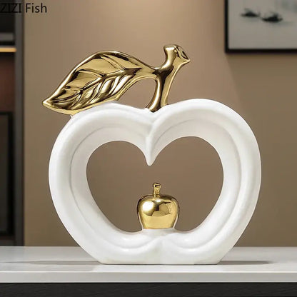 White and gold ceramic desk ornament featuring a pear shape with gold leaf and a smaller gold pear inside decorbites gold pear
