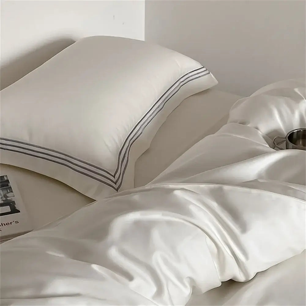 Cream-colored satin pillowcase with dark gray stitched lines in white and gray egyptian cotton bedding set decorbites 1200tc embroidered