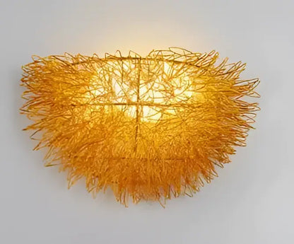 Golden intricately woven wire nest led wall lamp with warm glow for bedroom decorative lighting