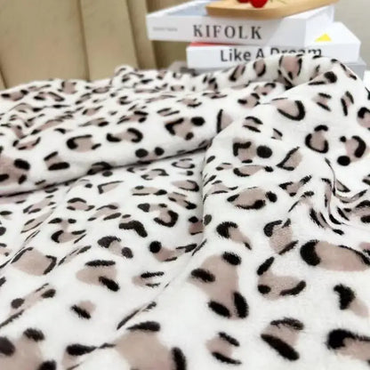 A plush white and orange leopard print warm fleece blanket by decorbites with soft fuzzy texture for bedroom decor