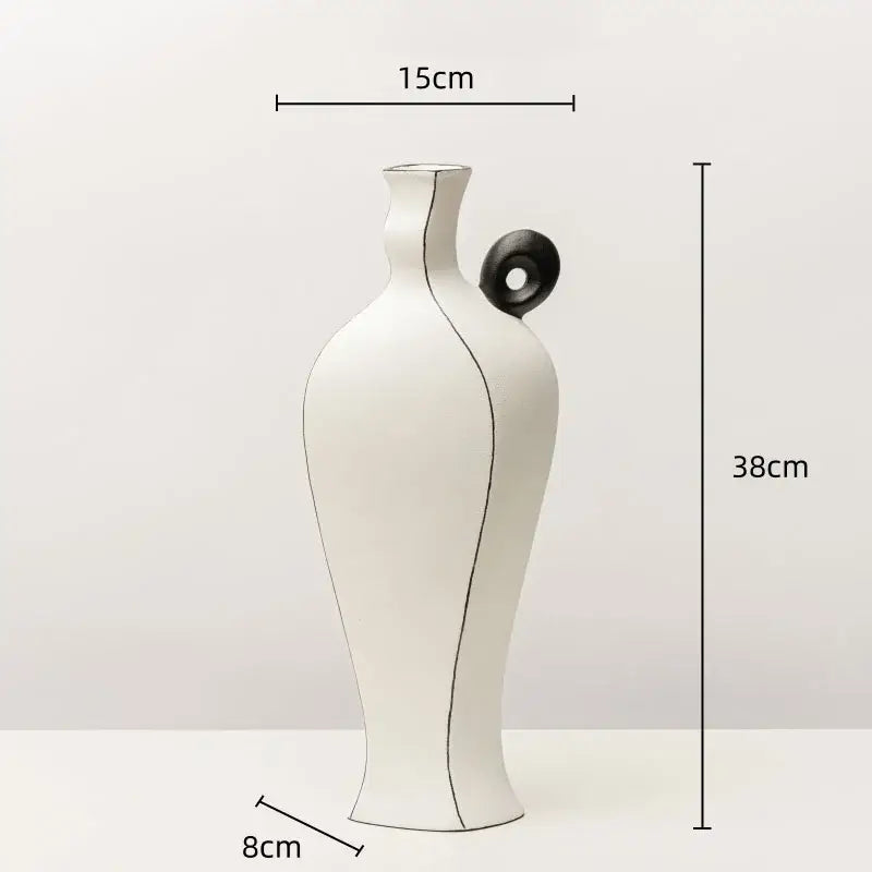 White ceramic vase with minimalist design featuring geometric black lines and a circular handle for living room decor
