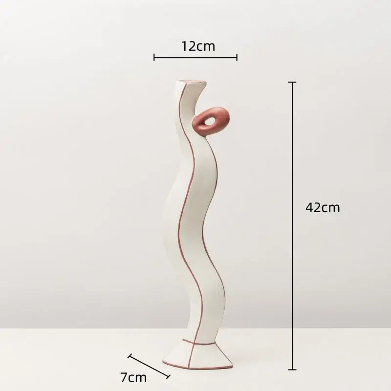 White ceramic vase with wavy design and pink accent featuring geometric black lines for living room decor