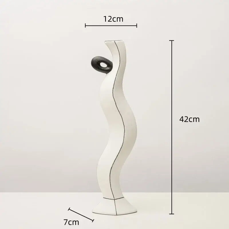 White ceramic vase with flowing form and black circular accent featuring geometric black lines for living room decor