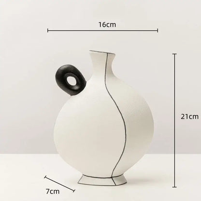 White ceramic vase with geometric black lines and a black circular handle for living room decor