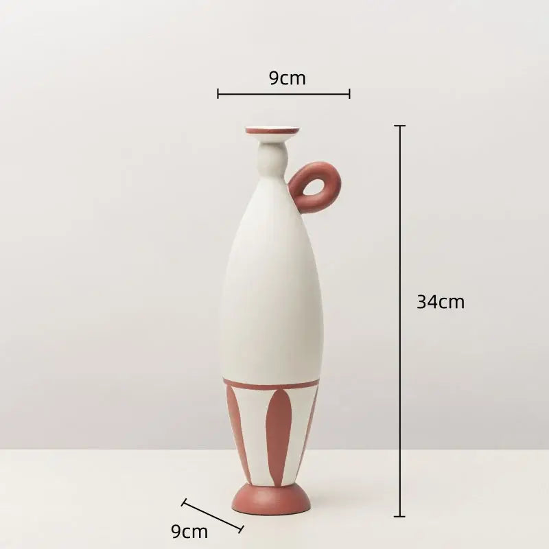 A tall slender white ceramic vase with terracotta geometric black lines and a matching handle for living room decor