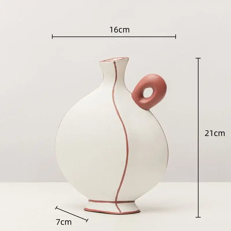 White ceramic vase with terracotta handle and geometric black lines for stylish living room decor