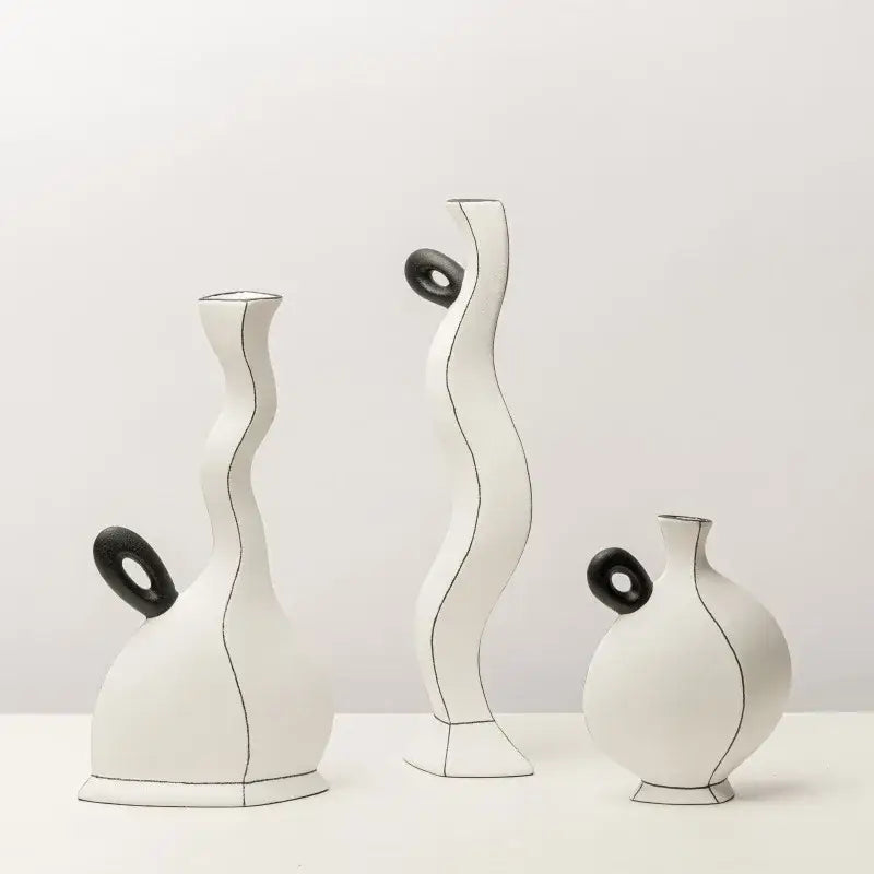 Three white ceramic vases with sleek black ring handles and subtle geometric black lines for living room decor