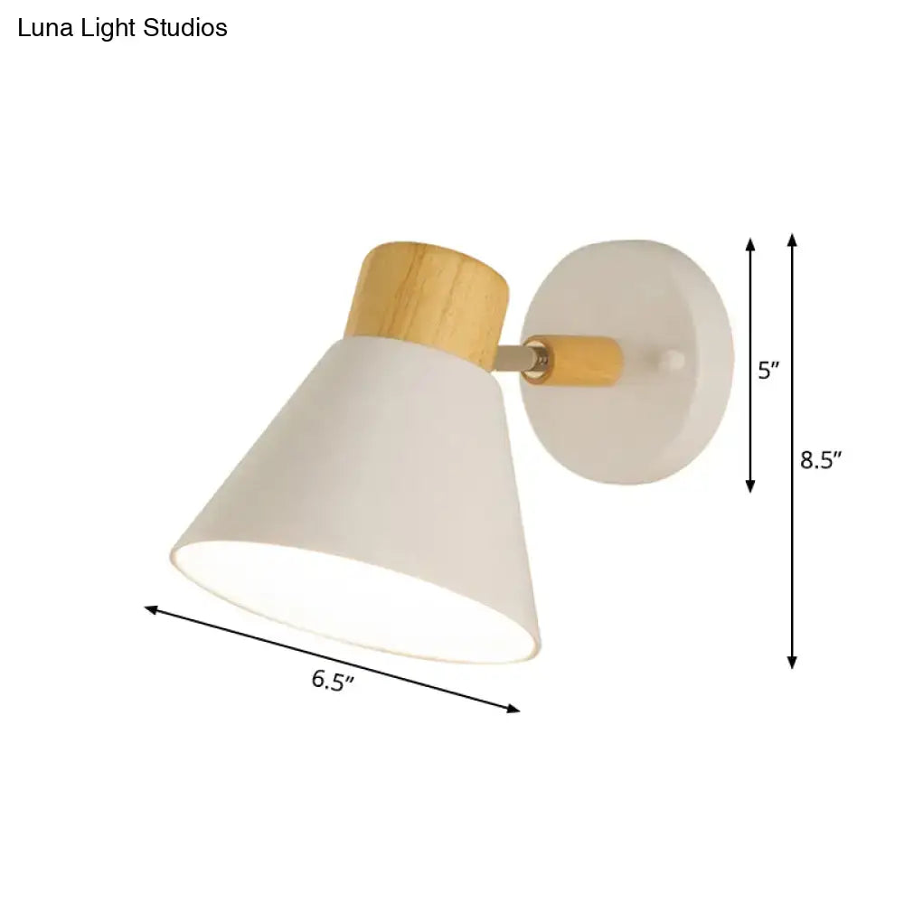 Minimalist wall mount light with matte white conical shade and natural wood accents for bedroom use