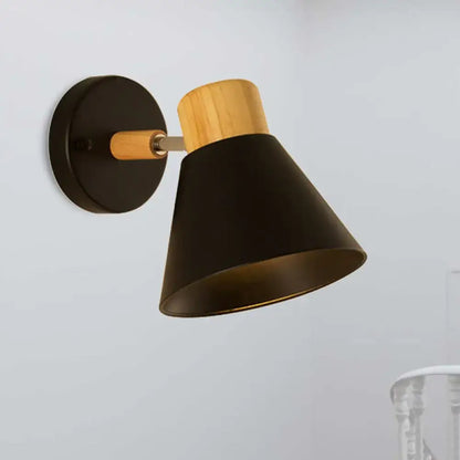 Black metal wall mount light with natural wood accent and matte finish for bedroom use as wall lamp