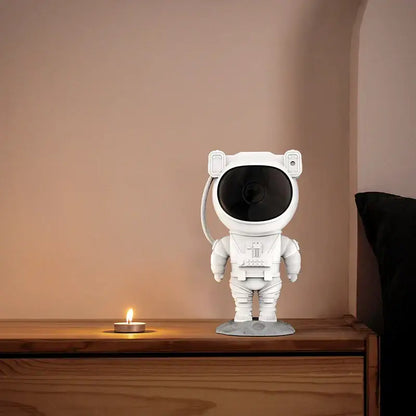 White astronaut star projector night light with black lens and gray base for bedroom galaxy decor