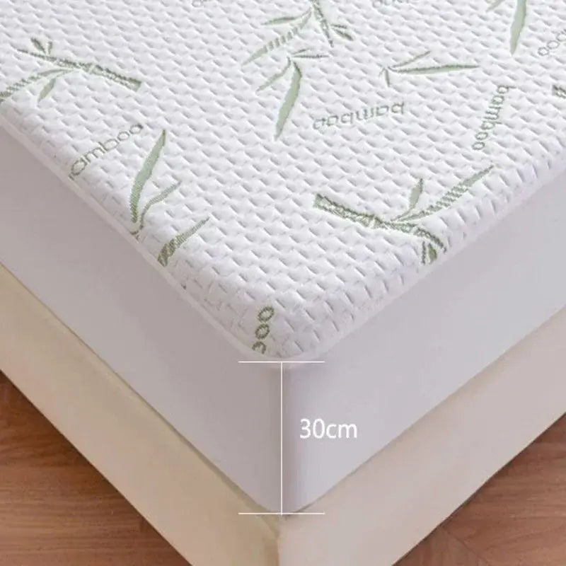 White bamboo jacquard waterproof fitted mattress cover with textured quilted surface and subtle green leaf motifs by decorbites