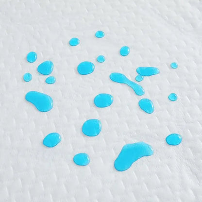 Bright blue liquid droplets on white bamboo jacquard waterproof fitted mattress cover showing absorbent texture
