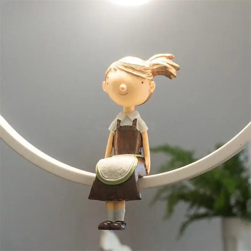 A beige resin figurine of a girl with blonde hair in ponytail paired with white bird iron ring pendant light decorbites iron ring pendant