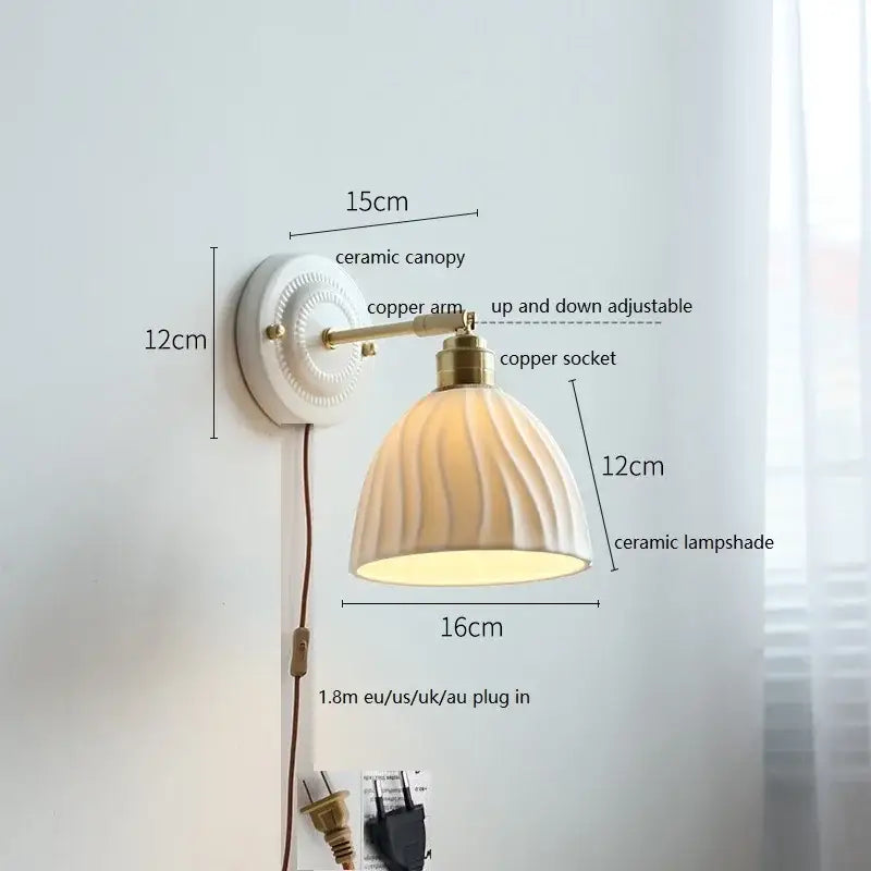 White butterfly ceramic led wall lamp featuring a scalloped ribbed ceramic shade and brass copper arm for bedroom use