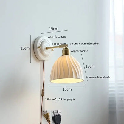 White butterfly ceramic led wall lamp featuring a scalloped ribbed ceramic shade and brass copper arm for bedroom use