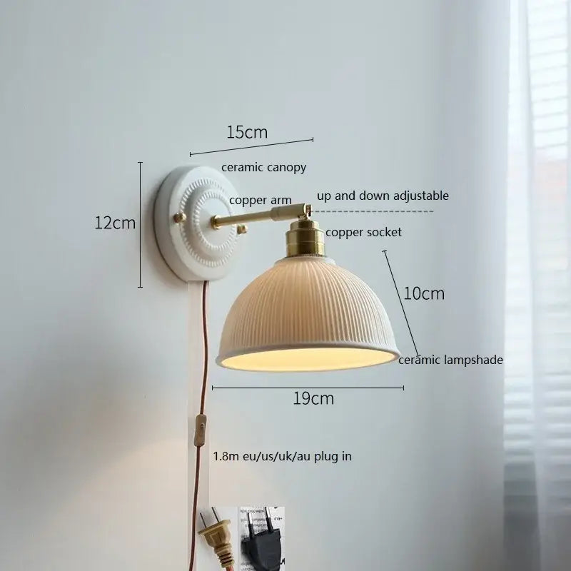 Cream-colored butterfly ceramic led wall lamp with ribbed scalloped shade and brass-finished copper arm for bedroom