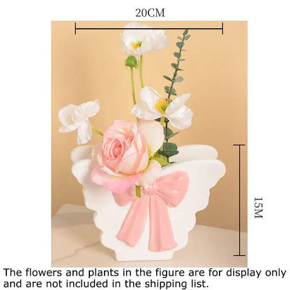 White butterfly ceramic vase with pink bow accent in angel wing shape for living room decor from decorbites butterfly ceramic collection