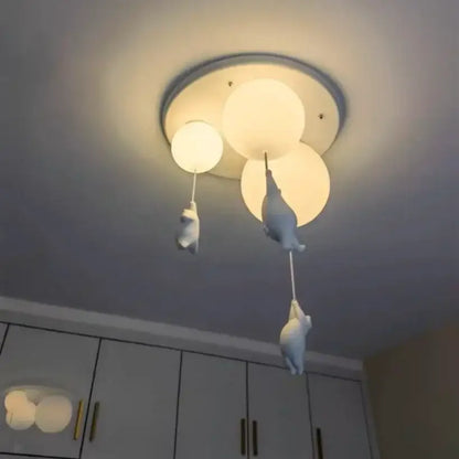 White ceramic bear pendant light with three spherical bulbs and dangling figurines for bedroom ceiling use