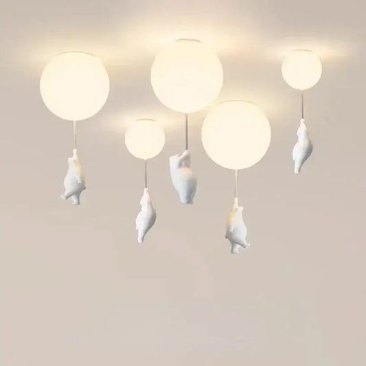 White ceramic balloon bear pendant light with bear figurines hanging below each globe for bedroom ceiling use