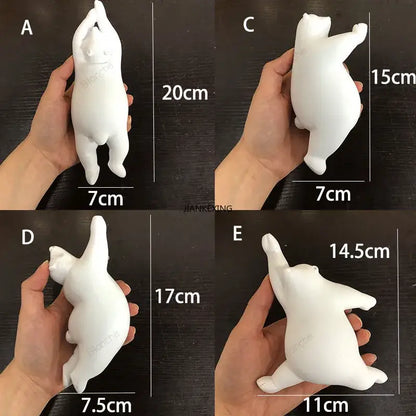 White ceramic polar bear figurines with rounded belly and stretched limbs in playful poses on a bear led ceiling chandelier