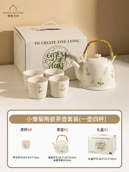 White ceramic daisy teapot set with delicate floral decals and woven bamboo handle in an elegant gift box