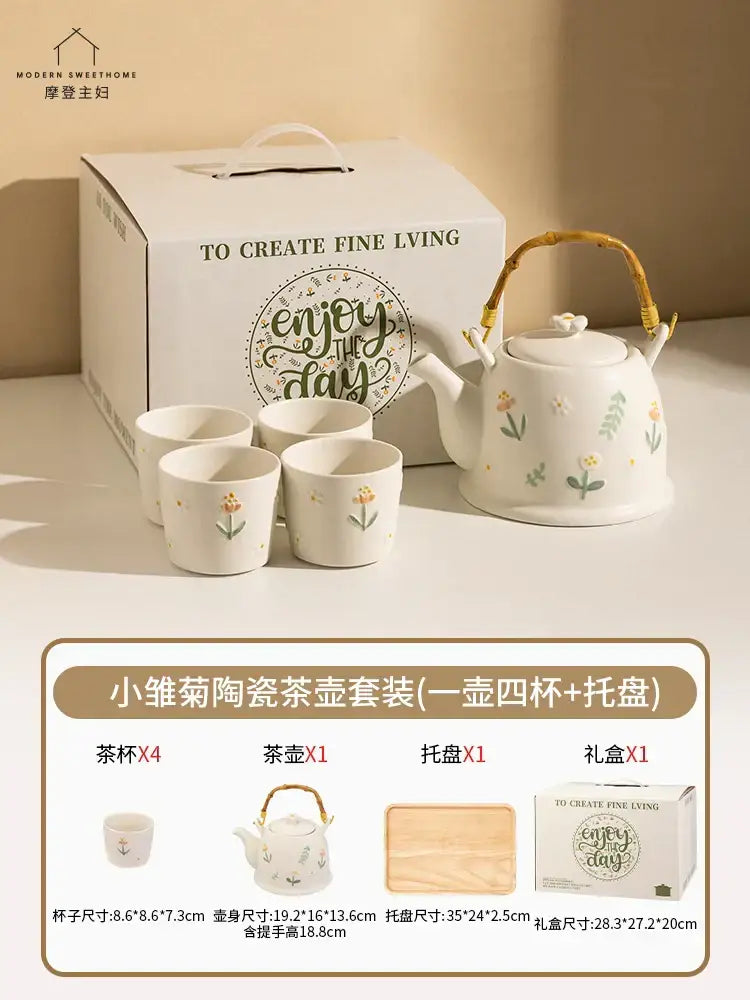 White ceramic daisy teapot set with floral decals and woven bamboo handle for elegant kitchen tea use
