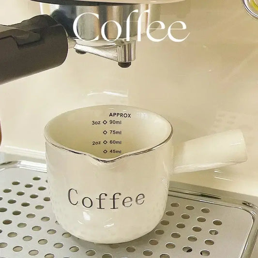 White ceramic espresso measuring cup with silver rim and handle marked coffee ideal as a milk pitcher and latte mixer decorbites espresso measuring product