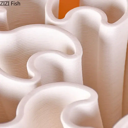 White wavy-edged plastic cookie cutters with glossy finish and visible 3d print layers for ceramic vase plant decor