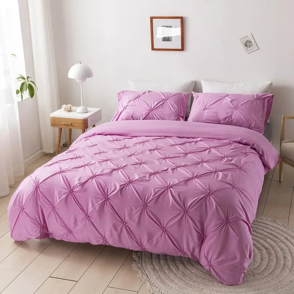 Pink quilted duvet cover set with soft satin finish and diamond-shaped pleats for elegant bedroom bedding