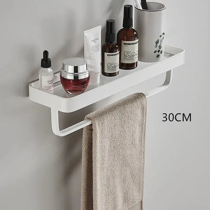 White double tier glass corner shelf with integrated towel bar holding toiletries and beige towel for kitchen storage