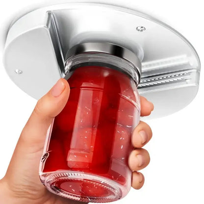 Silver metal easy twist jar opener mounted on ceiling grips glass jar with red contents for easy lid removal