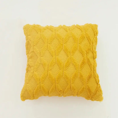 Cozy mustard-yellow throw pillow with textured diamond knit fabric and frayed edges as embroidered diamond cushion cover