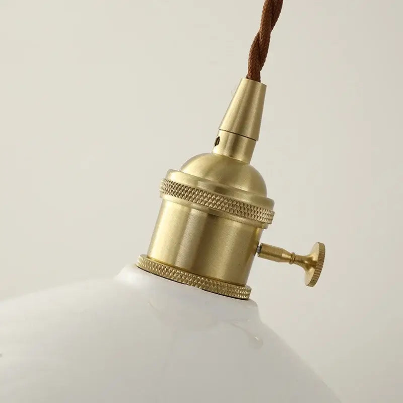 White enamel pendant light with brass-finished socket textured ridges brown cord and decorbites ceramic knob switch