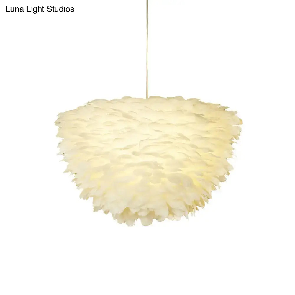 White floral pendant chandelier with cream-colored soft feather accents hanging from a thin cord for dining room